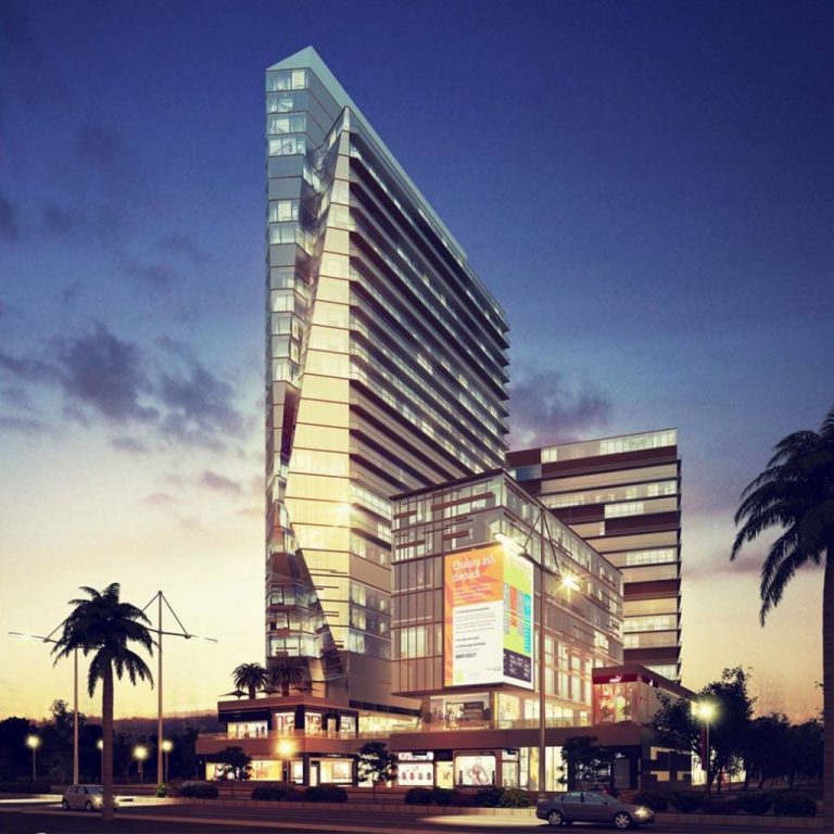 مبنيان ملونان تحت أضواء الليل، أحدهما كبير والآخر صغير، مع ألوان تميل إلى اللون الذهبي والشمس. | Two buildings illuminated at night, one large and the other small, with colors leaning towards golden and sunset hues.